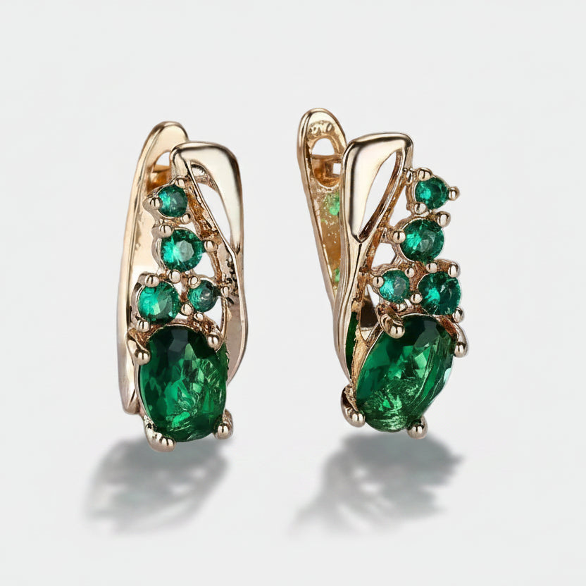Nora – Gold earrings with emerald accents.
