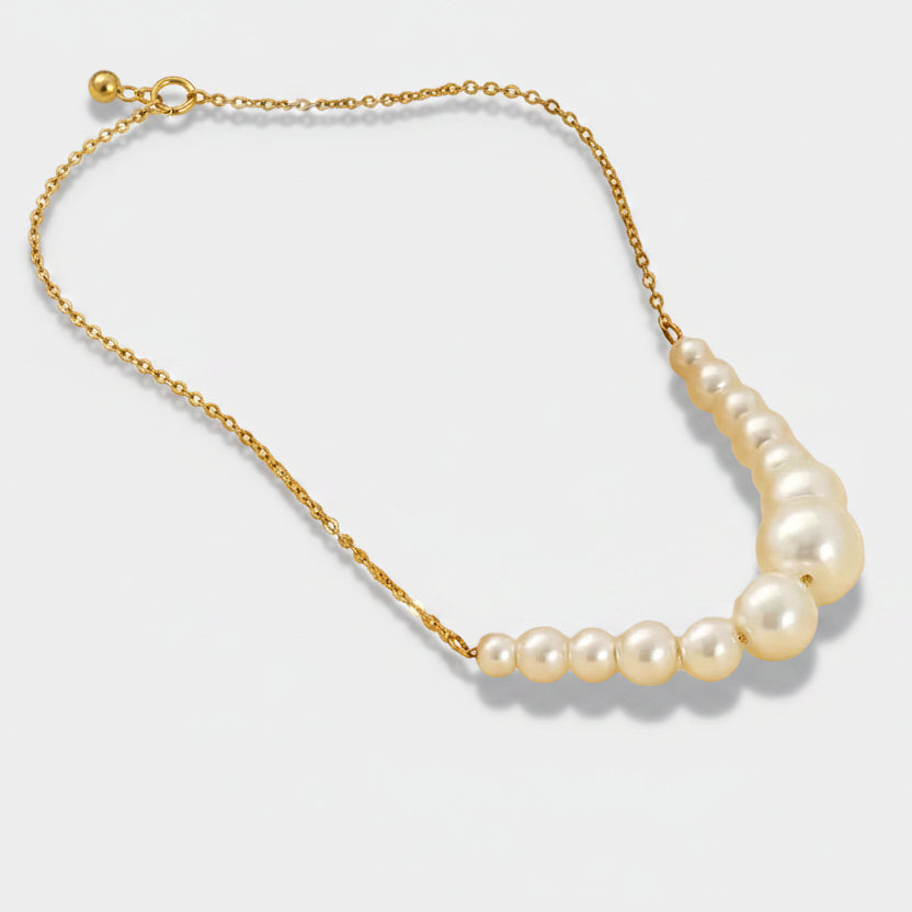 Anneliese – Shows earrings with gold lines and pearls.