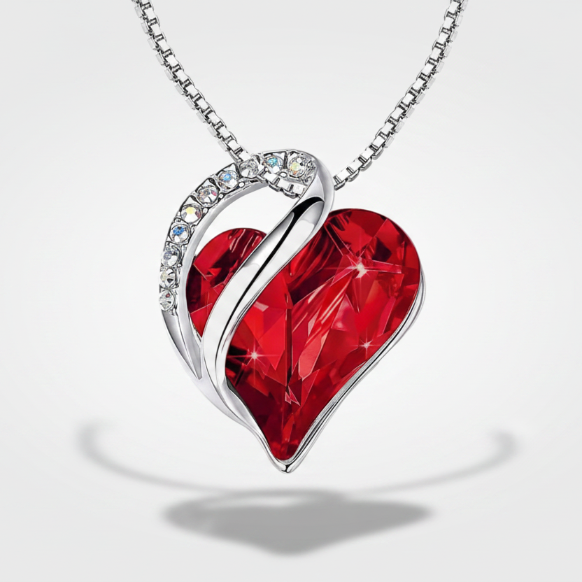 Hana-Marie – Heart-shaped pendant with rubies and silver reflections.