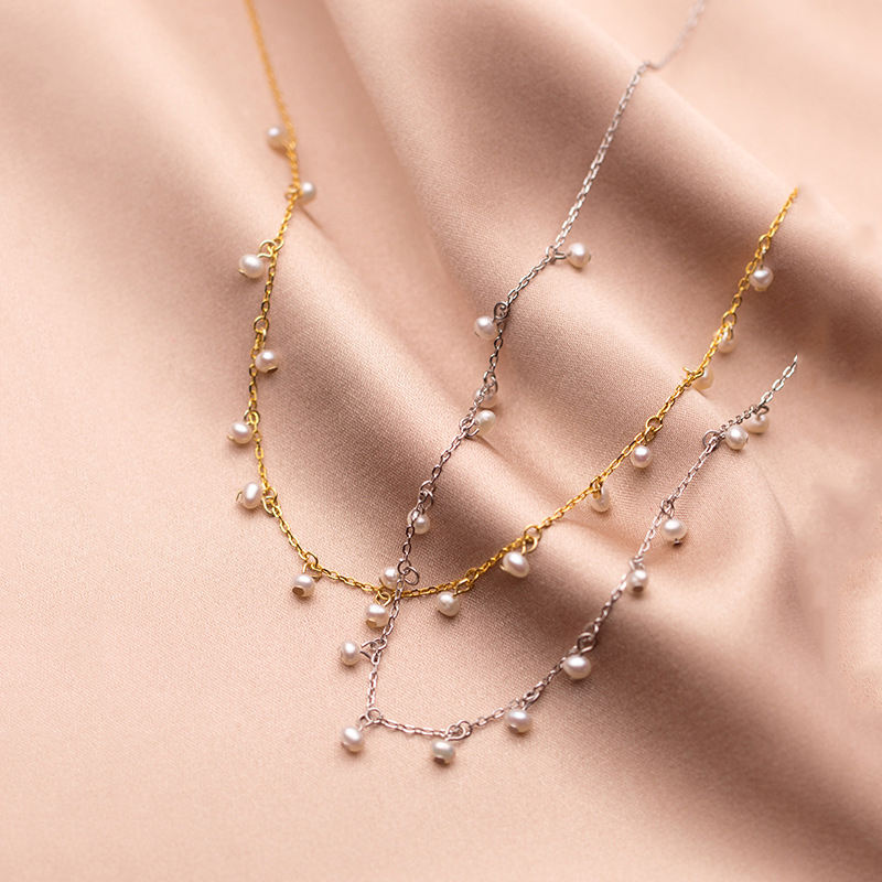 Irma – Round pearl earrings with textured gold edge.