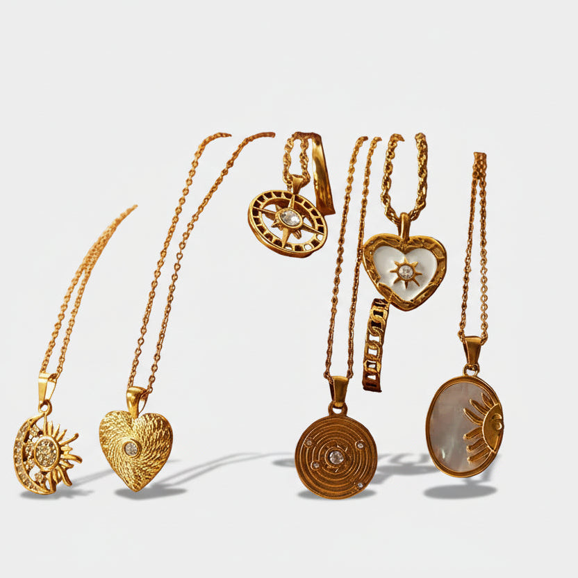 Alzbeta – Gold necklace with small symbolic pendants.