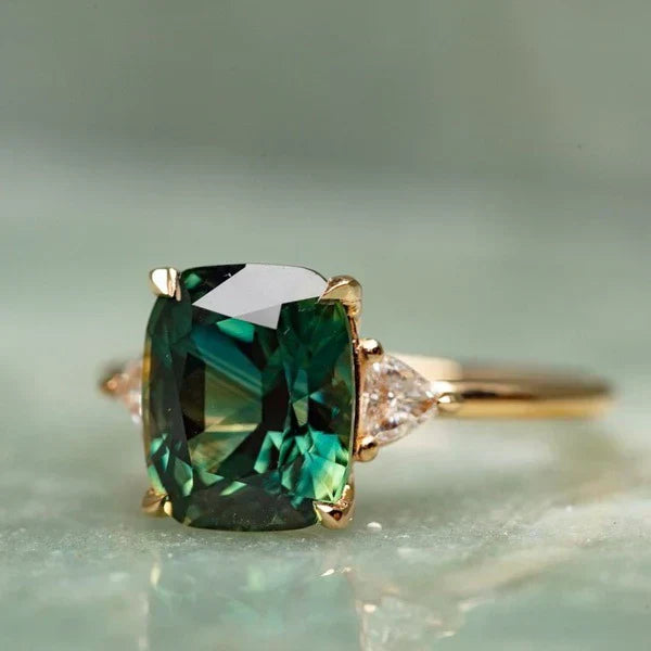 Emilie – Cushion-cut emerald ring.