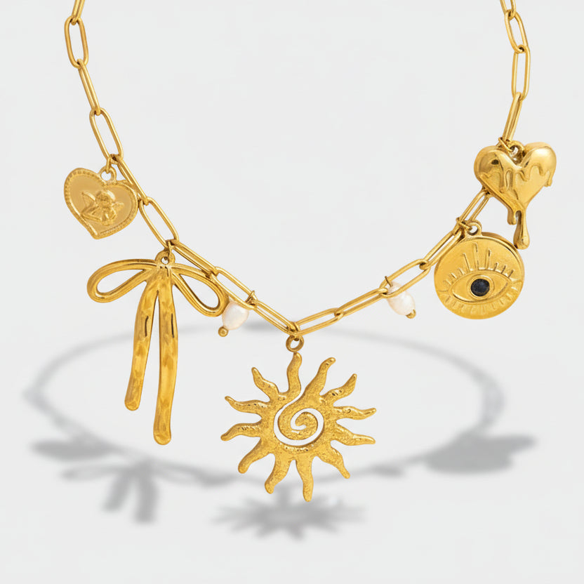 Emilie – Delicate gold necklace with small pendants.