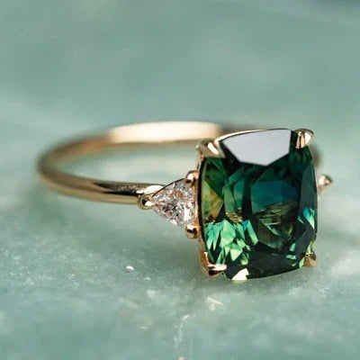Emilie – Cushion-cut emerald ring.