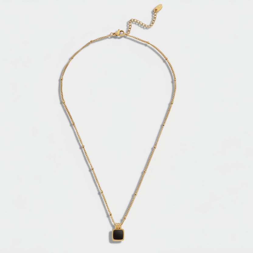 Selina - Gold necklace with dark stone.