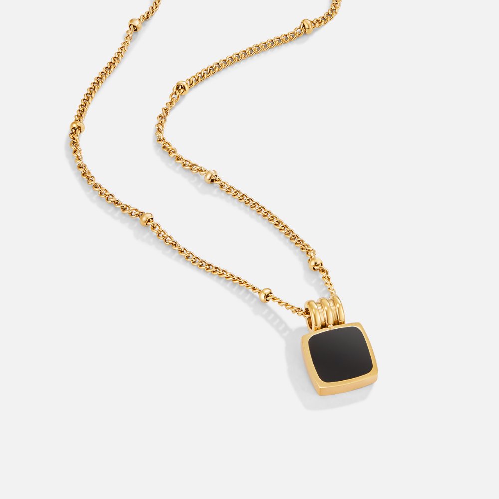 Selina - Gold necklace with dark stone.