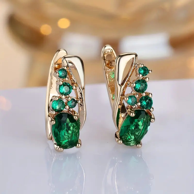Nora – Gold earrings with emerald accents.