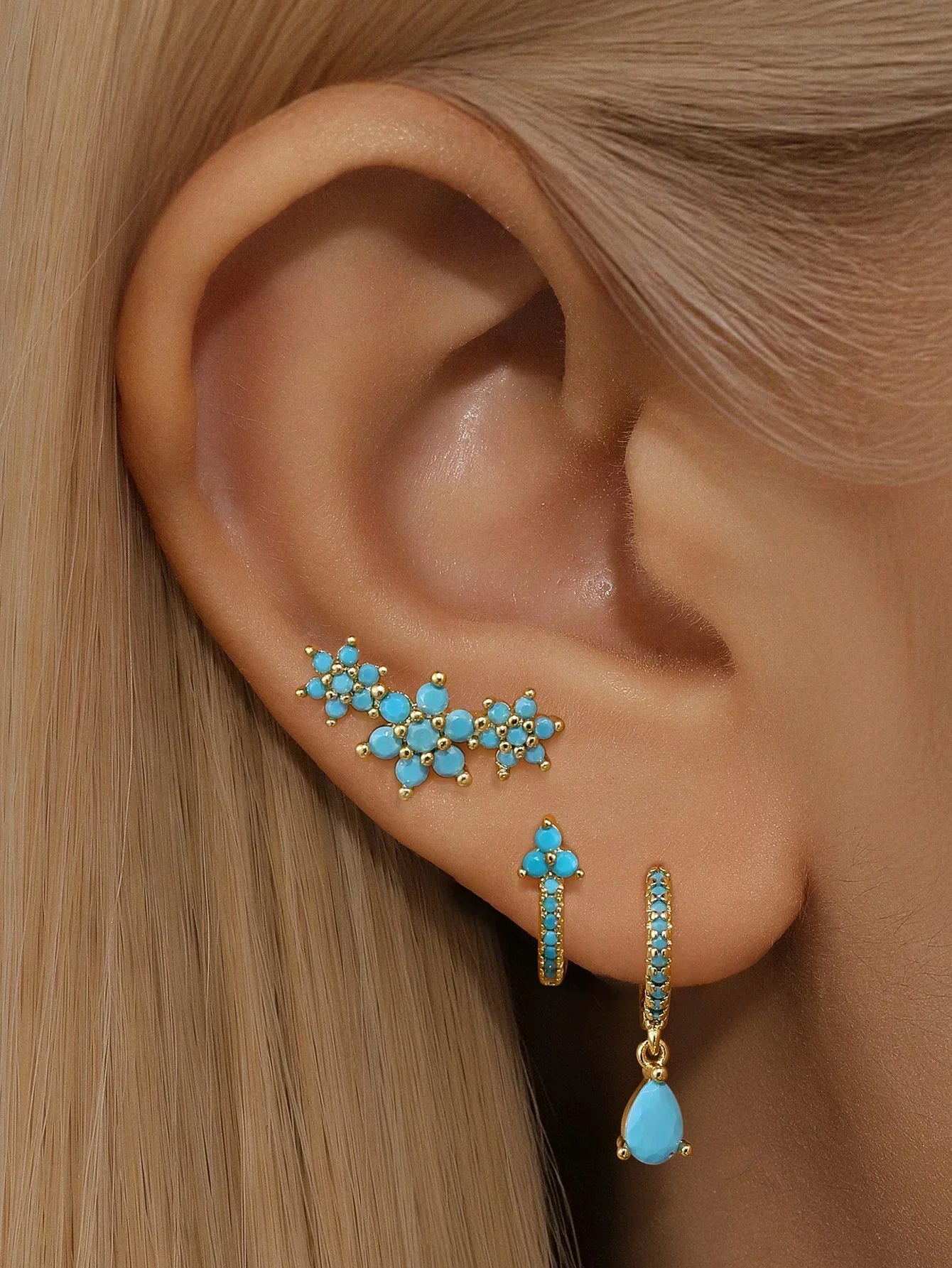 Gold earrings with a modern Victorian-Anne style silhouette.