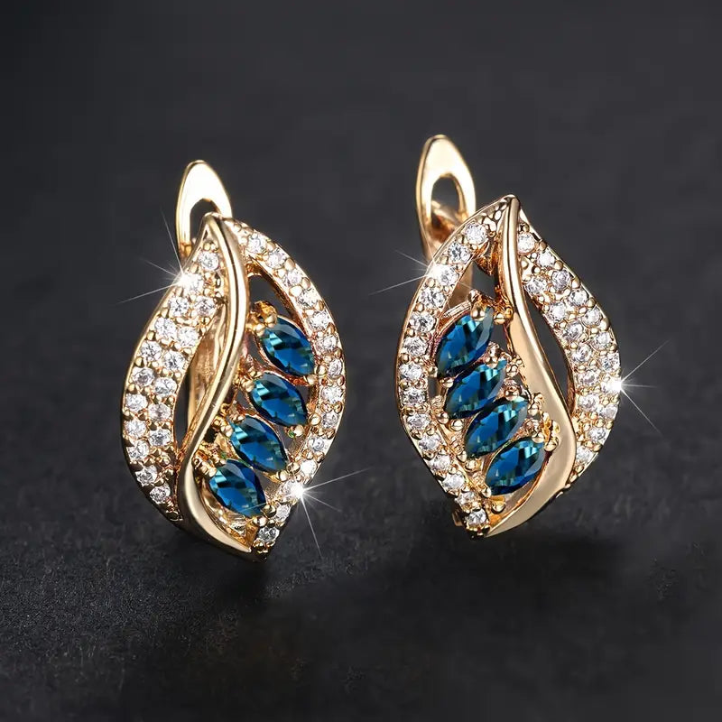 Nora – Gold earrings with sapphire and zirconia.